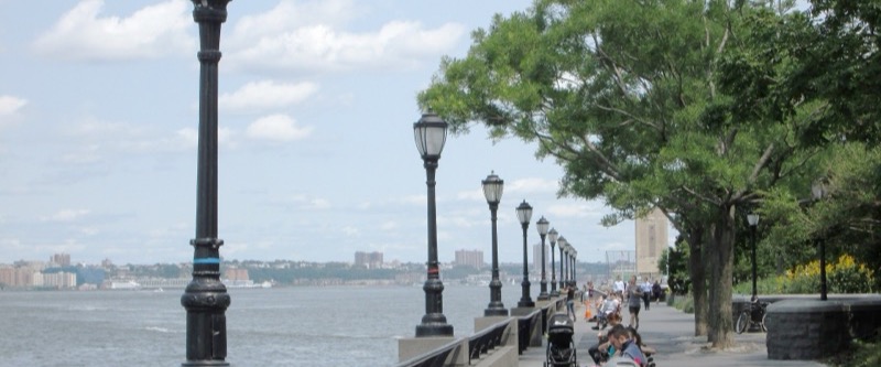 Lampposts, railing and trees along the Battery Park City Esplanade beside the Hudson River